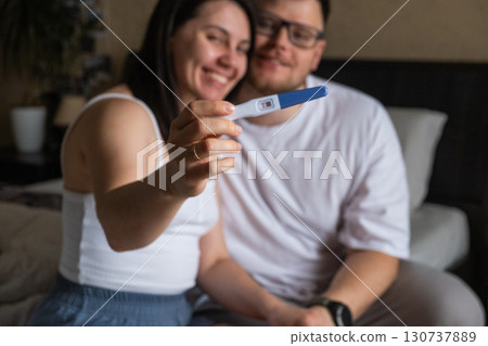 Happy Couple Celebrating Positive Pregnancy Test 130737889