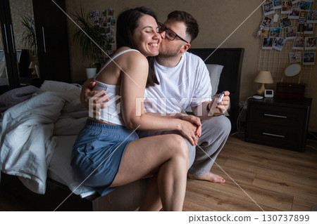 Happy Couple Celebrating Positive Pregnancy Test 130737899