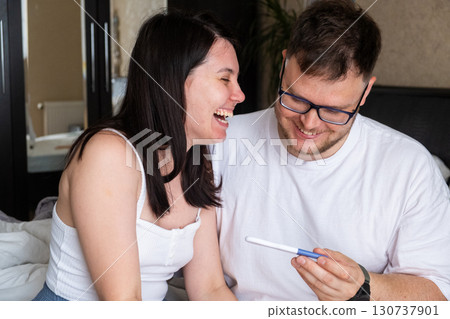 Happy Couple Celebrating Positive Pregnancy Test 130737901