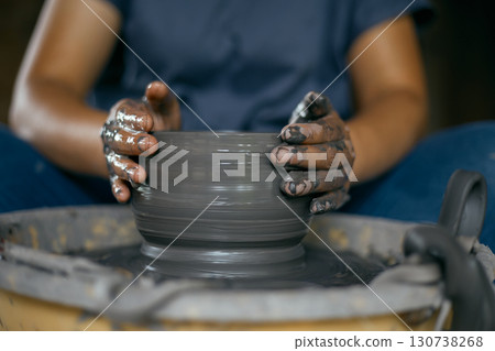 Hands of craftsman artist working on pottery wheel. Hands of craftsman artist working on pottery wheel. 130738268