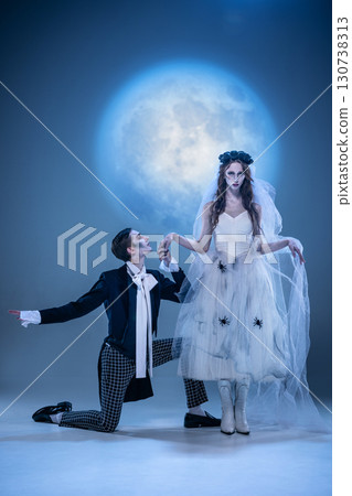 Gothic groom kneeling to pale bride in eerie moonlit ceremony Gothic groom kneeling to pale bride in eerie moonlit ceremony 130738313