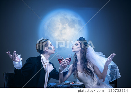 Surreal gothic couple kissing toast with glasses in eerie banquet Surreal gothic couple kissing toast with glasses in eerie banquet 130738314