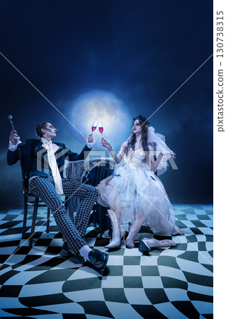 Elegant gothic couple raising glasses in surreal moonlit banquet Elegant gothic couple raising glasses in surreal moonlit banquet 130738315