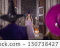 Enter If You Dare, Foolish Mortals... I've Got A Lot Of Candy! A Charming Witch In A Gown Smiles At Trick-Or-Treaters. 130738427