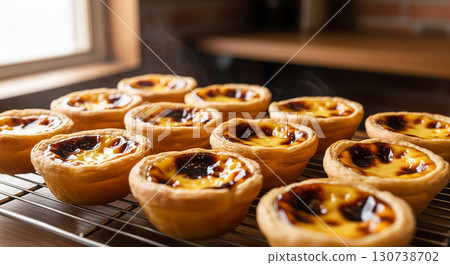 Freshly Baked Portuguese Egg Tarts on Cooling Rack Freshly Baked Portuguese Egg Tarts on Cooling Rack 130738702