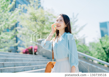 Business woman going up the stairs 130739516