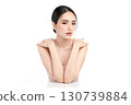 A beautiful young Asian woman with clean, fresh skin against a white background. Skincare, facial treatment, cosmetology, beauty, and spa. An elegant portrait of an Asian woman. 130739884
