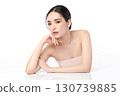 A beautiful young Asian woman with clean, fresh skin against a white background. Skincare, facial treatment, cosmetology, beauty, and spa. An elegant portrait of an Asian woman. 130739885