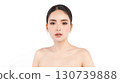 A beautiful young Asian woman with clean, fresh skin against a white background. Skincare, facial treatment, cosmetology, beauty, and spa. An elegant portrait of an Asian woman. 130739888
