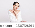 A beautiful young Asian woman with clean, fresh skin against a white background. Skincare, facial treatment, cosmetology, beauty, and spa. An elegant portrait of an Asian woman. 130739891