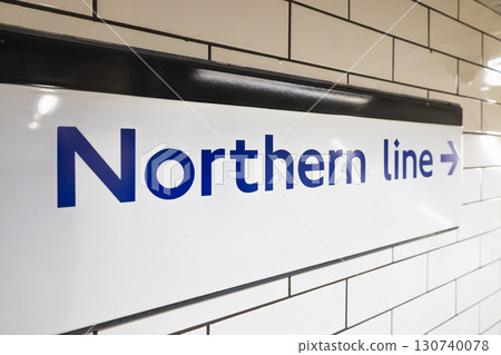 Northern line sign on London Underground wall, close up wayfinding arrow at station Northern line sign on London Underground wall, close up wayfinding arrow at station 130740078
