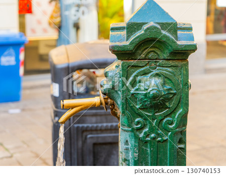 Old city fountain in Como Italy. Drinking tap water flows. Italian street Old city fountain in Como Italy. Drinking tap water flows. Italian street 130740153