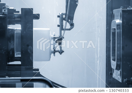 Close up scene material handling process the food container by robotic system from injection machine. 130740333