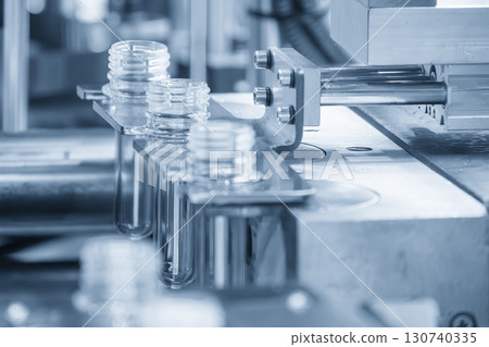 Close up scene the plastic bottle preform shape on the conveyor belt. 130740335