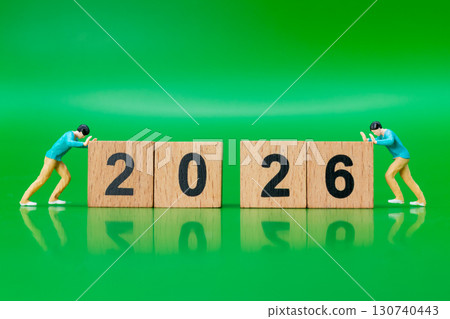 Miniature Man Pushing Wooden Number Blocks to 2026 130740443