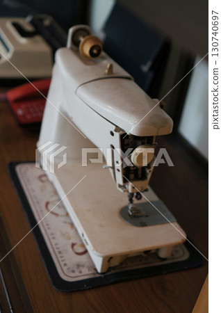 Vintage Sewing Machine on a wooden table 130740697