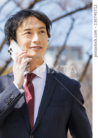 Businessman talking on smartphone Businessman talking on smartphone 130740712