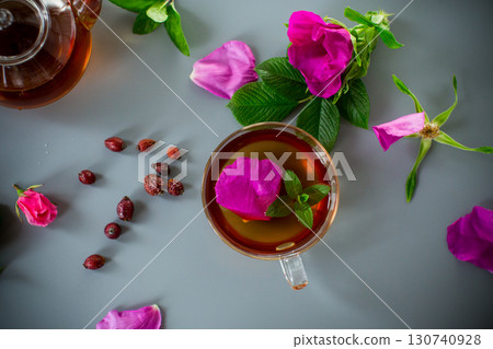 Aromatic natural drink with rosehip petals and a sprig of mint 130740928