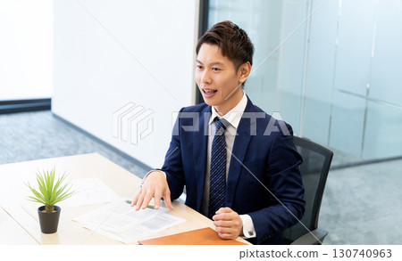 Smiling male businessman having a conversation Smiling male businessman having a conversation 130740963