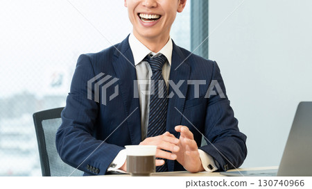 Smiling male businessman having a conversation 130740966