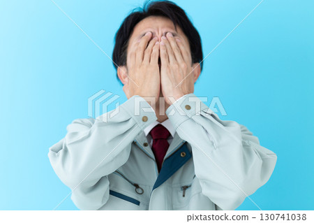 A middle-aged male businessman wearing work clothes who is worried A middle-aged male businessman wearing work clothes who is worried 130741038