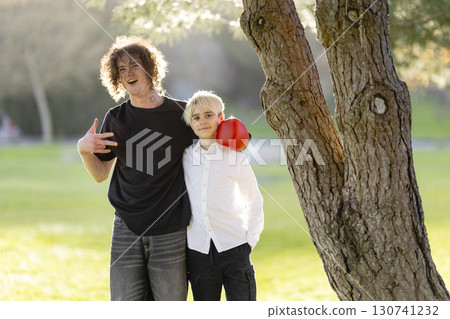 Two brothers boxing and having fun in park 130741232
