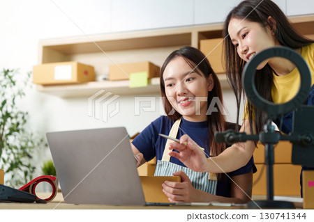 Digital Workspace. Women collaborating on e-commerce projects using a laptop. Digital Workspace. Women collaborating on e-commerce projects using a laptop. 130741344