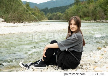 Modern Stylish Teenage Girl Outdoors Near the River. 130741403