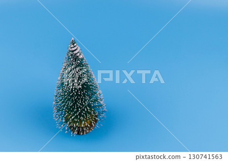 Christmas tree on a pastel blue background. Christmas or New Year concept. Minimal design 130741563