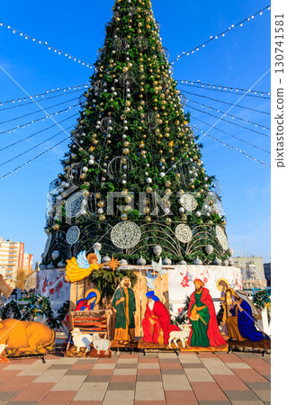 Decorated Christmas tree and Christmas Nativity scene in a city park Decorated Christmas tree and Christmas Nativity scene in a city park 130741581