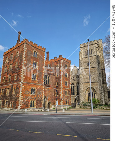 Morton's Tower, the gatehouse to Lambeth Palace, residence of Archbishop of Canterbury in London, United Kingdom. Historical street view to the classic red brick palace under a bright blue sky 130741949