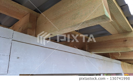 Wooden roof beams and metal roofing structure close-up Wooden roof beams and metal roofing structure close-up 130741998