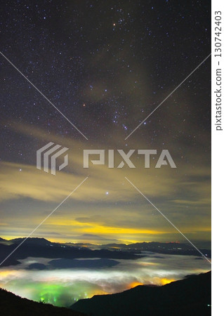 A sea of clouds and a starry sky surrounding Hakuba Village seen from Happo-one 130742403