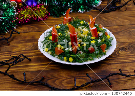 Salad Christmas wreath and Christmas decorations on a wooden table Salad Christmas wreath and Christmas decorations on a wooden table 130742440