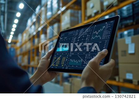 Manager is using digital tablet with inventory management software to check stock and optimize supply chain in warehouse 130742821