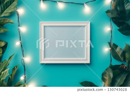 White frame surrounded by green leaves and string lights glowing on a turquoise background, perfect for showcasing your designs White frame surrounded by green leaves and string lights glowing on a turquoise background, perfect for showcasing your designs 130743028
