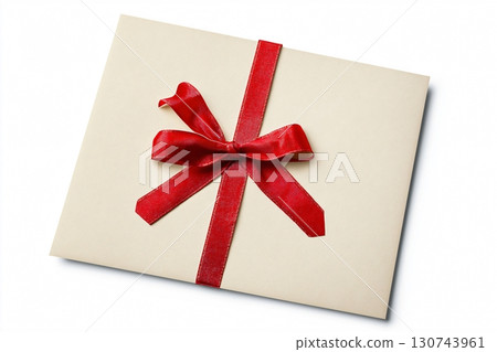 Elegant Christmas gift certificate with a red ribbon is lying on a white background 130743961