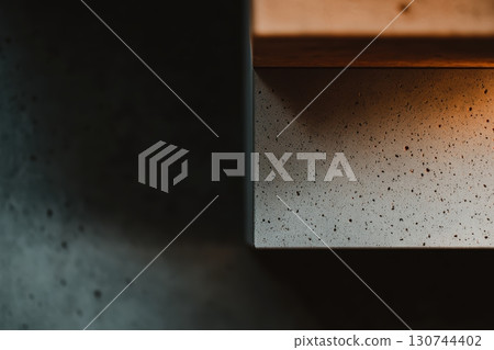 Modern concrete surface with warm lighting at a cozy kitchen setting Modern concrete surface with warm lighting at a cozy kitchen setting 130744402