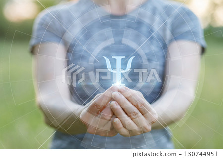 Symbol of psychology held in hands in serene outdoor setting Symbol of psychology held in hands in serene outdoor setting 130744951