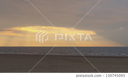 Sunset on the beach near beautiful sea in the evening. Yellow sunlight. Vacation in Ostend, Belgien. Nature background. 130745093
