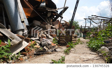 View to destroyed residential buildings at Kharkivska oblast. Ruined houses after bomb attacks on ukrainian territory from russia army. Consequences of russian invasion of Ukraine. Slow motion 130745326