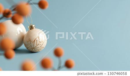 Elegant Christmas decoration with a maple leaf ornament and winter berries on a calm, serene blue background. 130746058