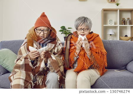Frozen elderly couple is sick at home during autumn cold and suffers from colds. Frozen elderly couple is sick at home during autumn cold and suffers from colds. 130746274