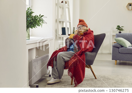 Senior Man Braving the Cold in Home Living Room Senior Man Braving the Cold in Home Living Room 130746275
