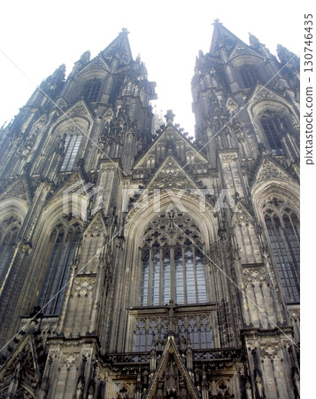 Majestic Cologne Cathedral Facade Rising Against a Bright Sky in Germany 130746435
