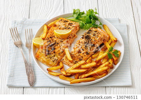 Baked salmon fillet with french fries on plate Baked salmon fillet with french fries on plate 130746511