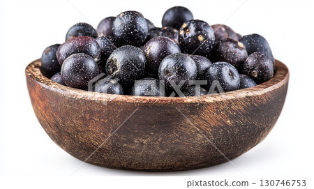 Close up photo of dried acai berries in a wooden bowl, superfood 130746753