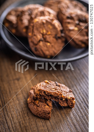 Sweet chocolate cookies on wooden table. Sweet chocolate cookies on wooden table. 130747025
