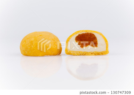 Yellow mochi ice cream cut in half with creamy and caramel center on white background 130747309