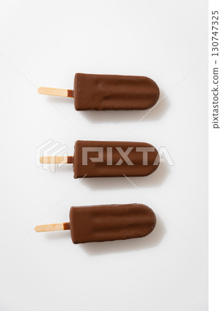 Chocolate ice cream popsicles on white background. Minimalist summer dessert concept 130747325